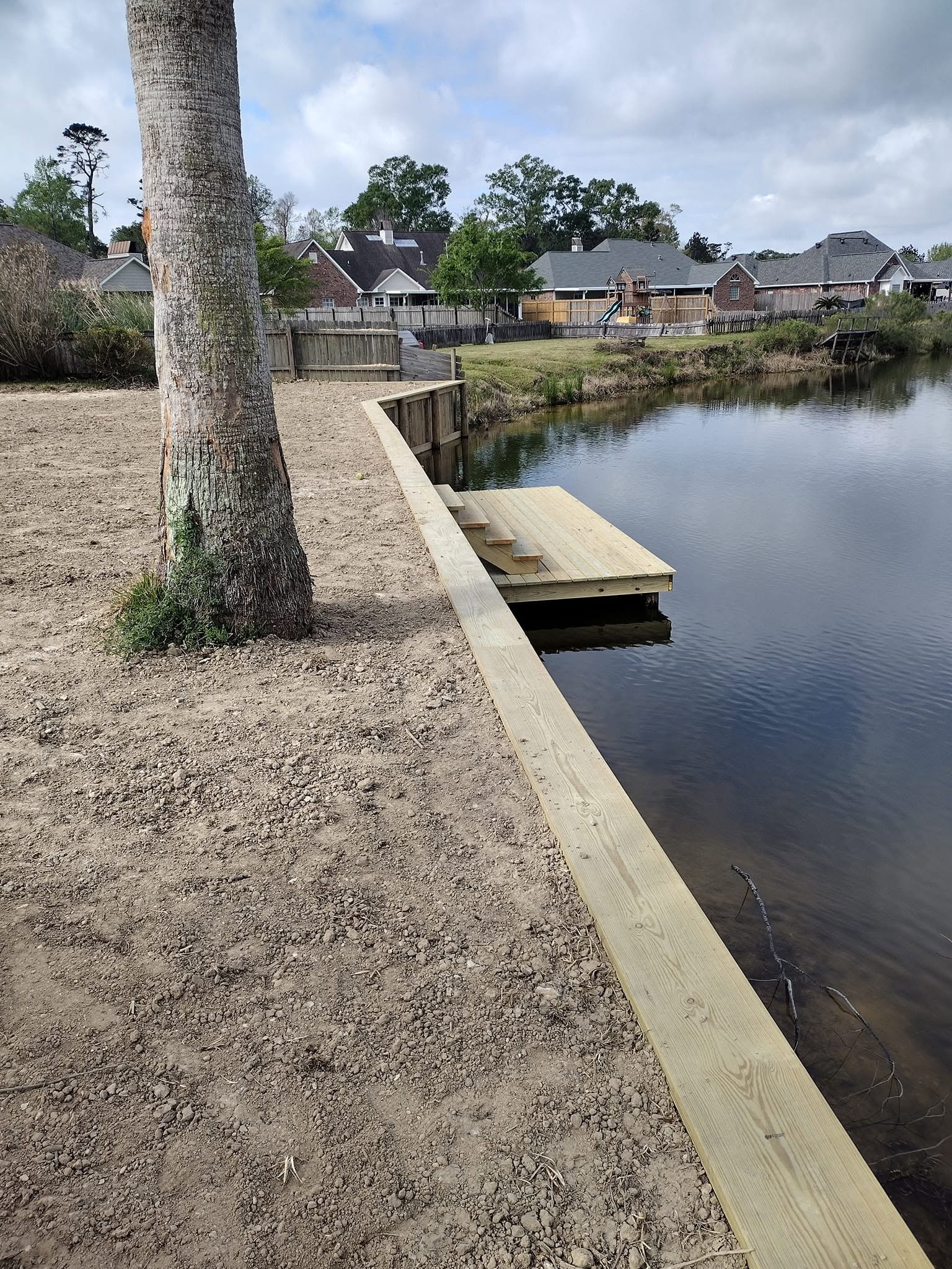 Backyard canal bulkhead and dock, Southeast Louisiana Backyard canal bulkhead and small dock protecting a waterfront lot in Southeast Louisiana