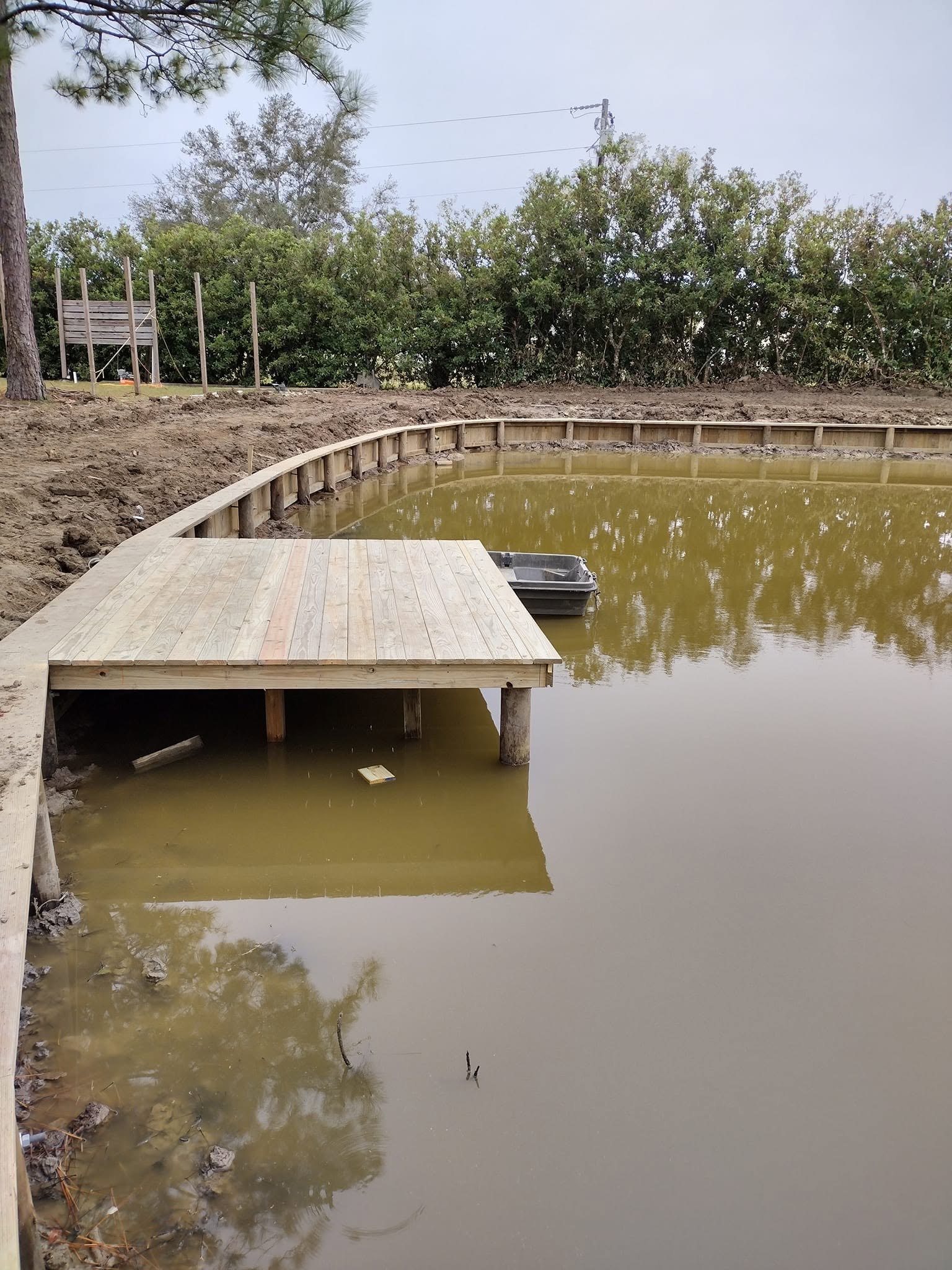 Bayou boat dock and bulkhead construction, Louisiana Treated pine boat dock and curved bulkhead built along a Louisiana bayou