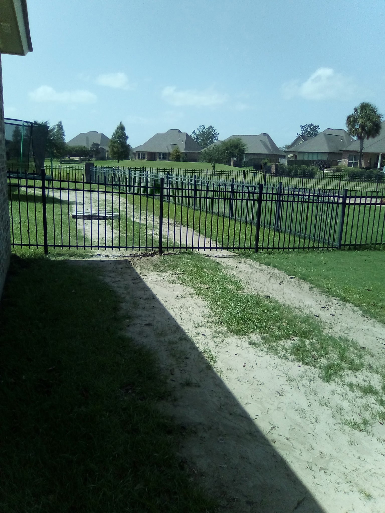 Ornamental aluminum fence and gate, Louisiana Black ornamental aluminum fence and gate running along a Louisiana subdivision walkway