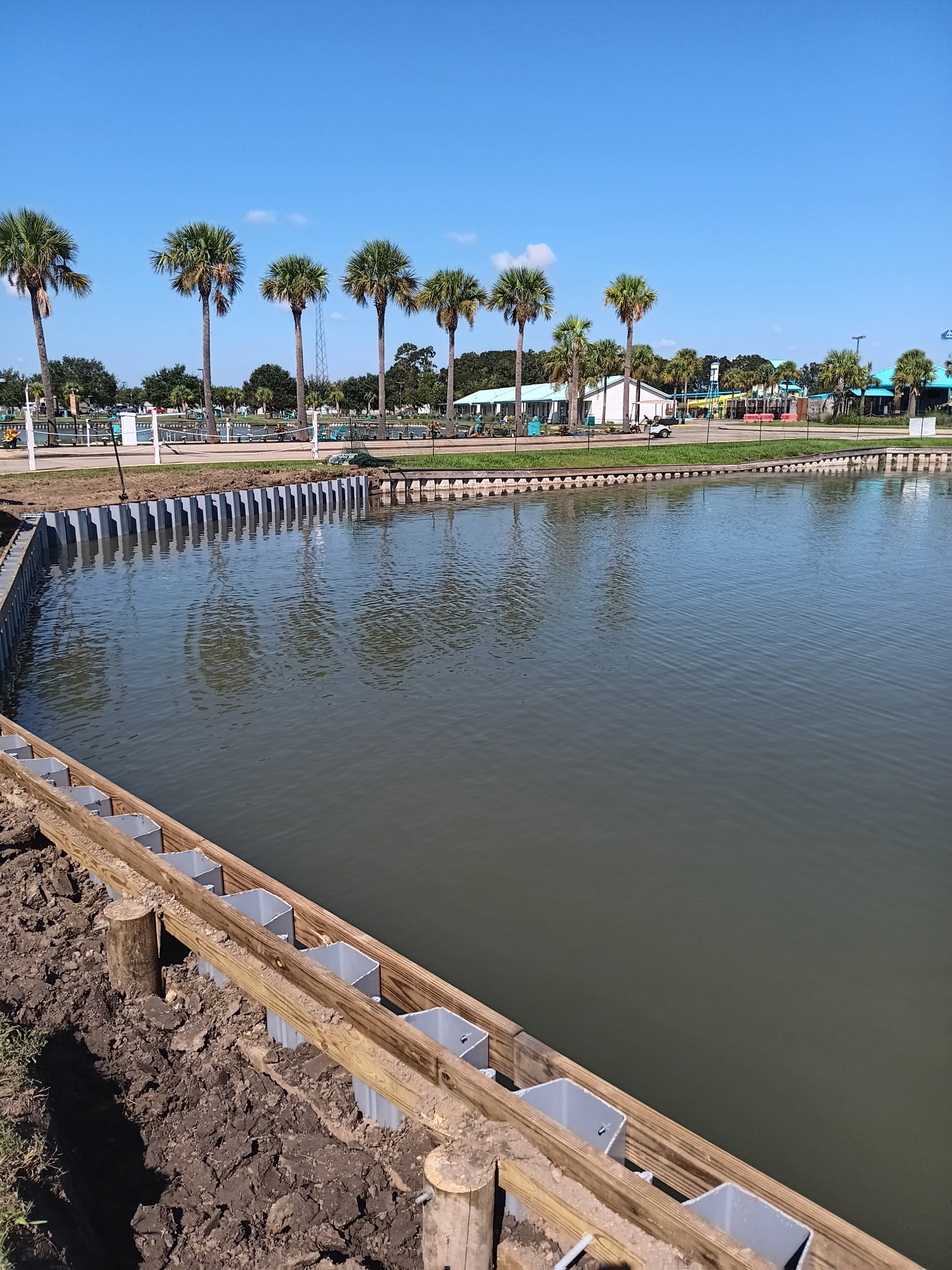 Completed sheet pile bulkhead, South Louisiana Completed sheet pile bulkhead curving around a lake shoreline in South Louisiana